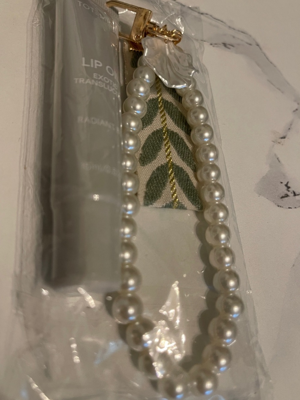 Lip oil with faux Pearl Beaded Wristlet Keychain with Green Leaf Accent